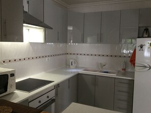 Large open plan kitchen lots dishes  cutlery etc 
Fridge freezer
