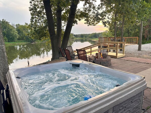 4 person hot tub overlooking river and firepit.