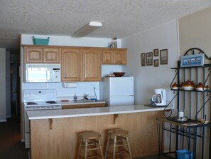 Fully equipped kitchen.  Stove with oven and large refrigerator with freezer. 