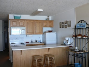 Fully equipped kitchen.  Stove with oven and large refrigerator with freezer. 