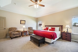 Comfy king size bedroom has a sitting area