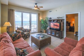 Living Room with full-wall of windows and balcony overlooking the Gulf