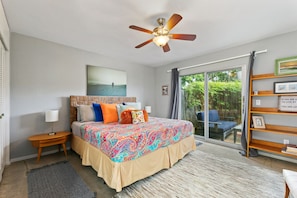 Bright master bedroom with a King bed and walk out to the patio.