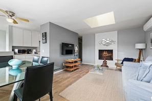 Lovely living room with a skylight and AC unit.
The fireplace is to not be utilized.