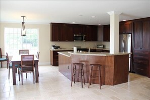Kitchen and Dining Area With All New Appliances 
