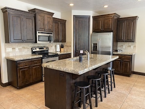 Full kitchen w/granite countertops and stainless steel appliances. 