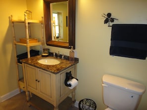 The bathroom has a very quaint decor.