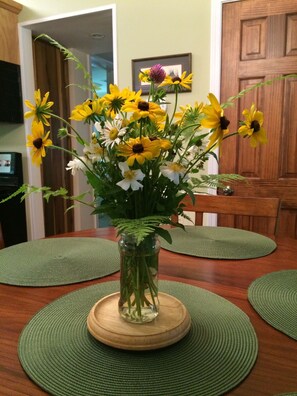 A fresh bouquet of meadow flowers greets guests when in season.