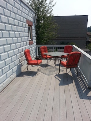 Outdoor table on deck.  We have an umbrella too!