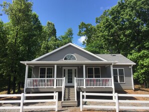 Wooded setting with traditional exterior color theme