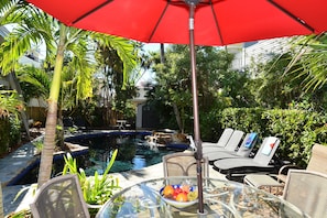 Gumbo Limbo's lagoon style black bottom pool w a waterfall, tranquility, BBQ