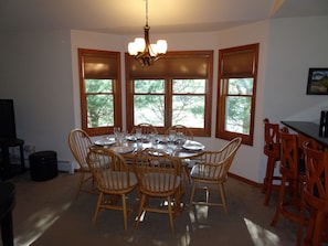 Dining room table comfortably accommodates up to six guests.