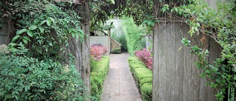 Pass on side of main house to access private studios across the lawn behind.