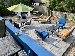 Weber Genesis, fenced in back-yard, picnic table, chaises, and seating.
