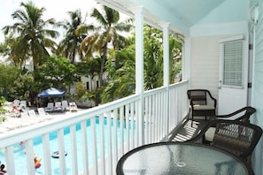 Private balcony overlooking swimming pool. Nice table set for outside dinning.