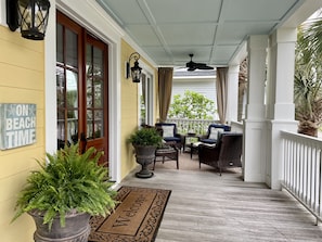Gracious front porch with sitting area adjoining a king bedroom 