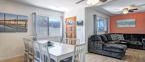 The dining room looks in the family room with a large sectional sofa.