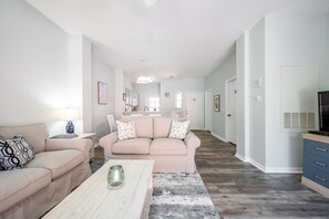 Bright Living room facing towards dining area and kitchen