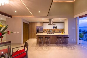 Open living dining and kitchen with a loft above.