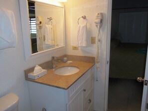 New vanity with a granite top and a waterfall faucet.