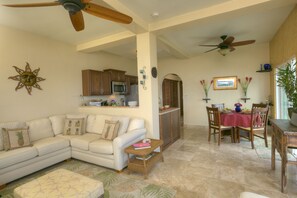 Large main living and dining area with travertine floors throughout.