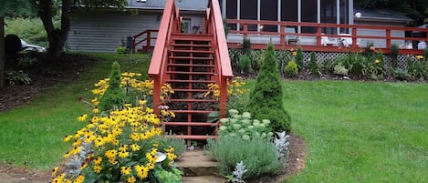 The CreekHouse front view with stairs leading to the spectacular screened porch.