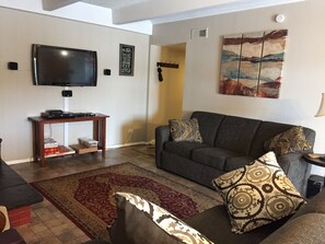Living room area includes a sofa & love seat, rocker,TV, and a gas fireplace.
