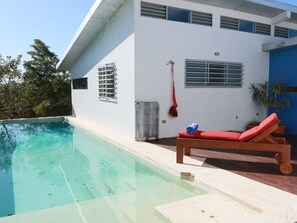 Pool deck with hammock & lounge chair. Morning view 