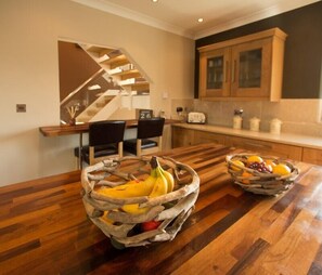 Modern kitchen with wooden island and bar also lots of nice upgrades.