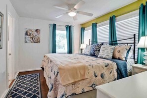 Retreat to master bedroom with king size bed, new bed linens, dresser, LED TV and closet