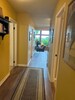 Hallway out of kitchen towards front door. Three bedrooms along the hall 
