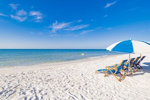The beach and ocean are steps away from this condo