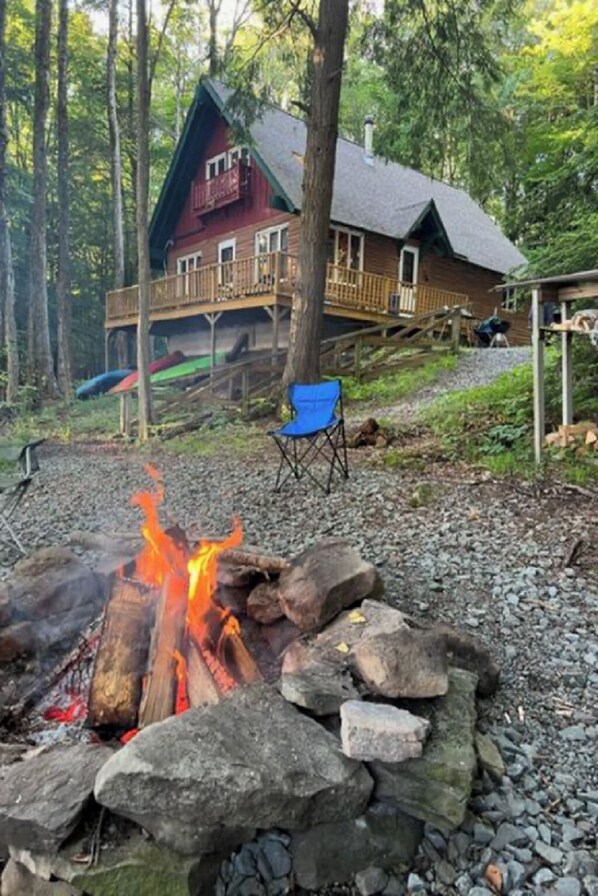 Campfire pit with camp chairs, Tiki torches and covered firewood provided