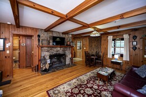 Living room has large fireplace available for use. 