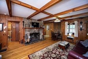 Living room has large fireplace available for use.