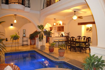 View of pool, dining room and kitchen form chaise lounge