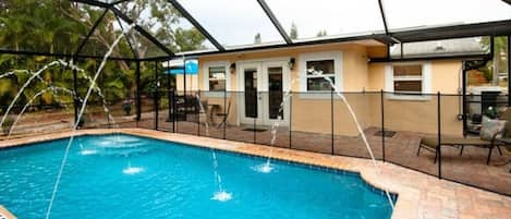 Gorgeous heated private swimming pool with dramatic multiple fountains, relaxing massage therapy jets, screen enclosure to keep pests out, & self-serve Tiki Bar! 