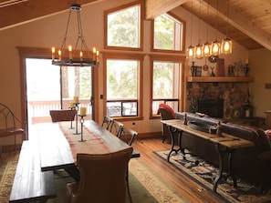 Dining Area with large table, cathedral windows and chateau lighting.