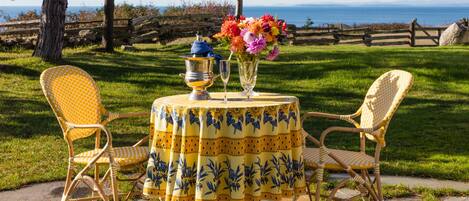 Dining outside with a view of the sea on your private patio. (not water front)