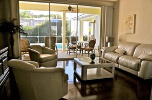 Sitting room with patio and pool view