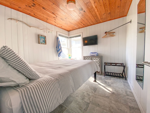 Master Bed of the Original 1950's cottages features the original knotty pine