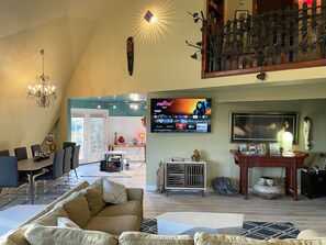 Living room with 18' tall ceiling and a 65" Smart Fire TV.