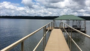 Private dock with electricity, lights, and covered boat slip.