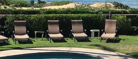 Our heated pool with the beach just 50 feet past our lava rock wall. 