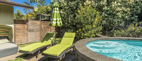 Backyard pool deck with chaise lounge seating