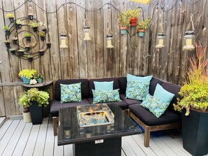 Private patio with comfy lounge sectional, fire pit & outdoor smart TV 