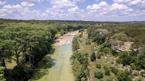 Aerial view of the 25 acre Shade Ranch on the right side. Looking north and down river of the Blanco River.