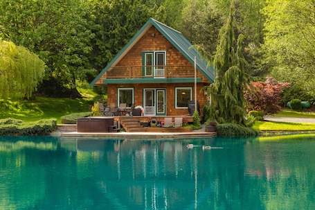 View of the cabin from across the pond. Ducks often visit. Photo by Stevenflow.