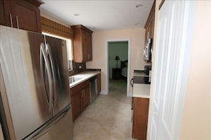 Stainless kitchen with LG appliances and full size LG Washer/Dryer