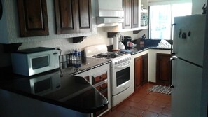 Fully stocked kitchen with granite countertops